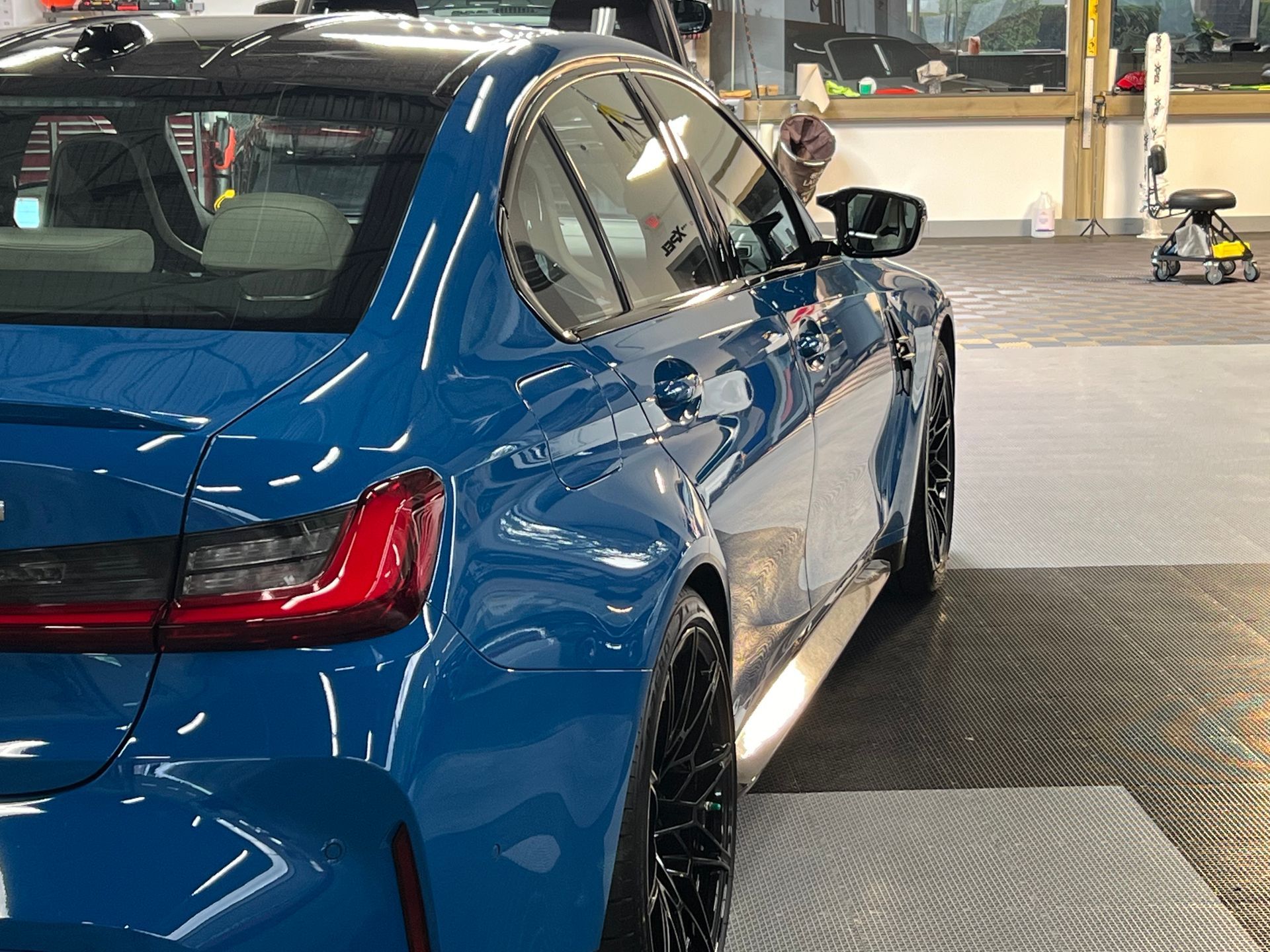 A close up of water drops on the hood of a car