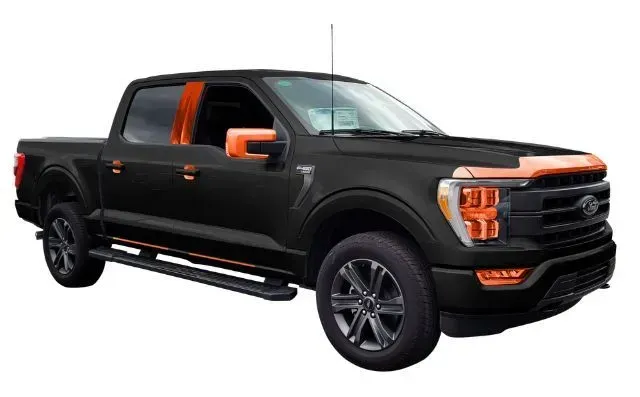A black and orange ford f150 truck on a white background.