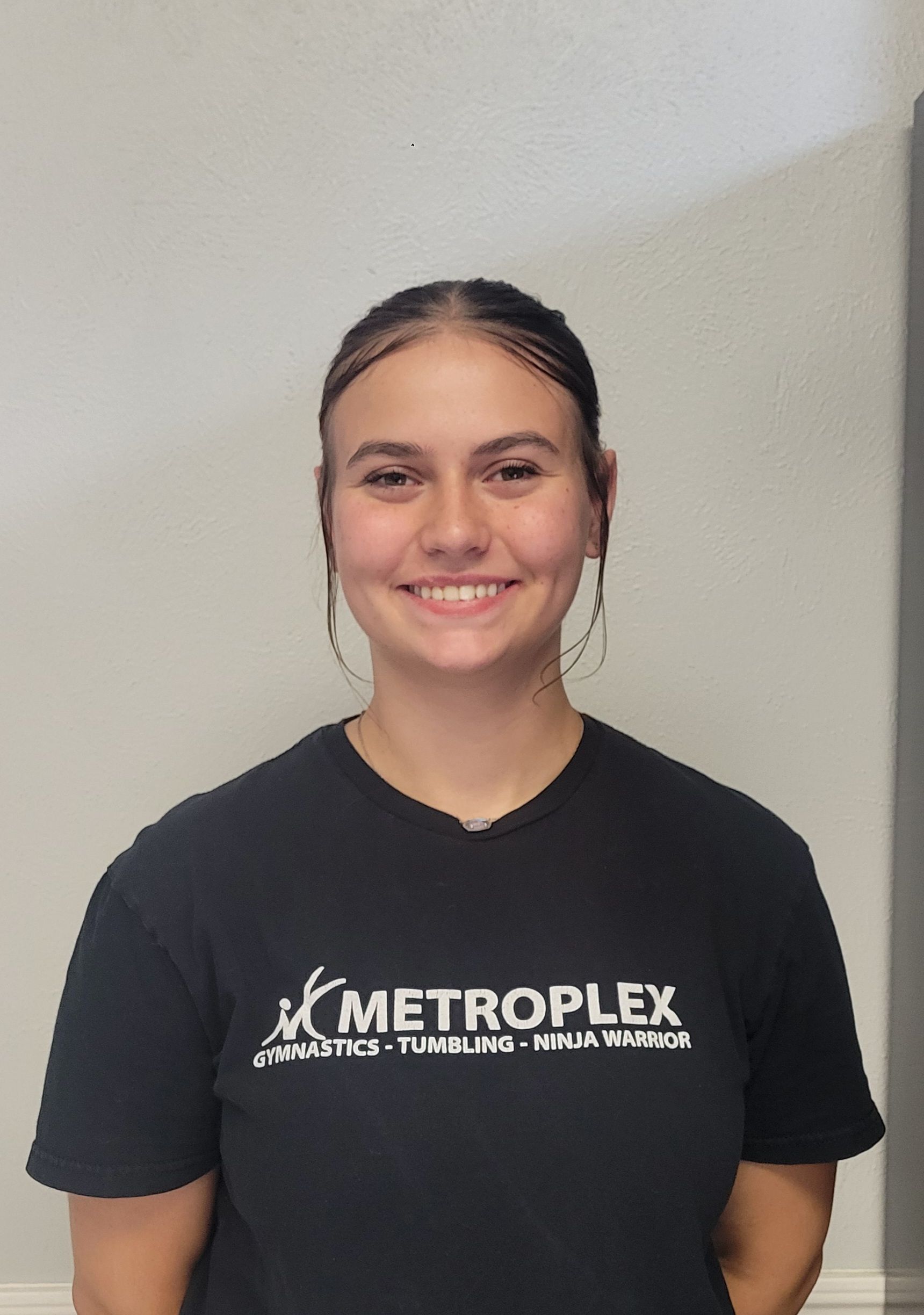 Woman in black shirt smiling; METROPLEX logo.