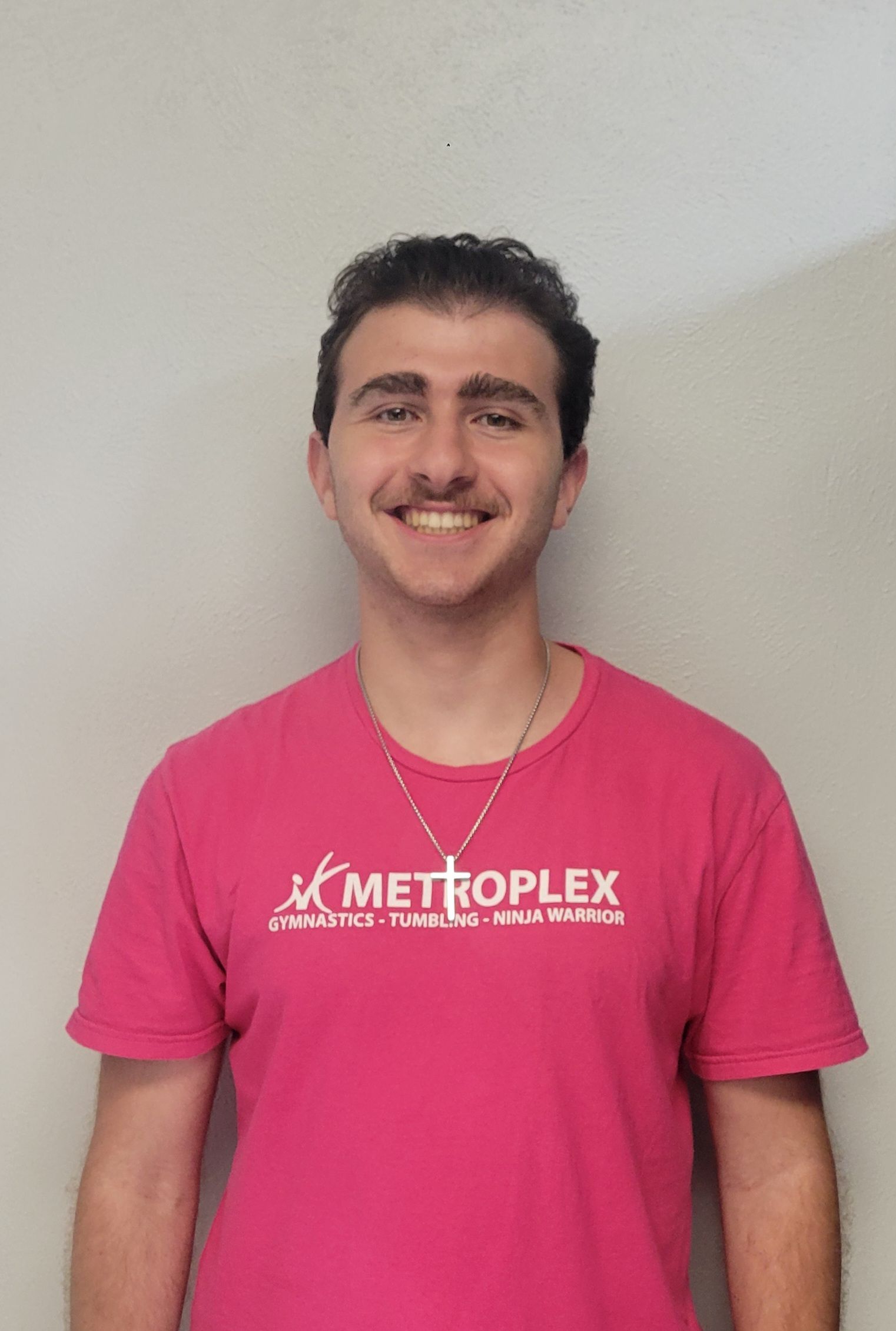 Smiling person in pink t-shirt with 