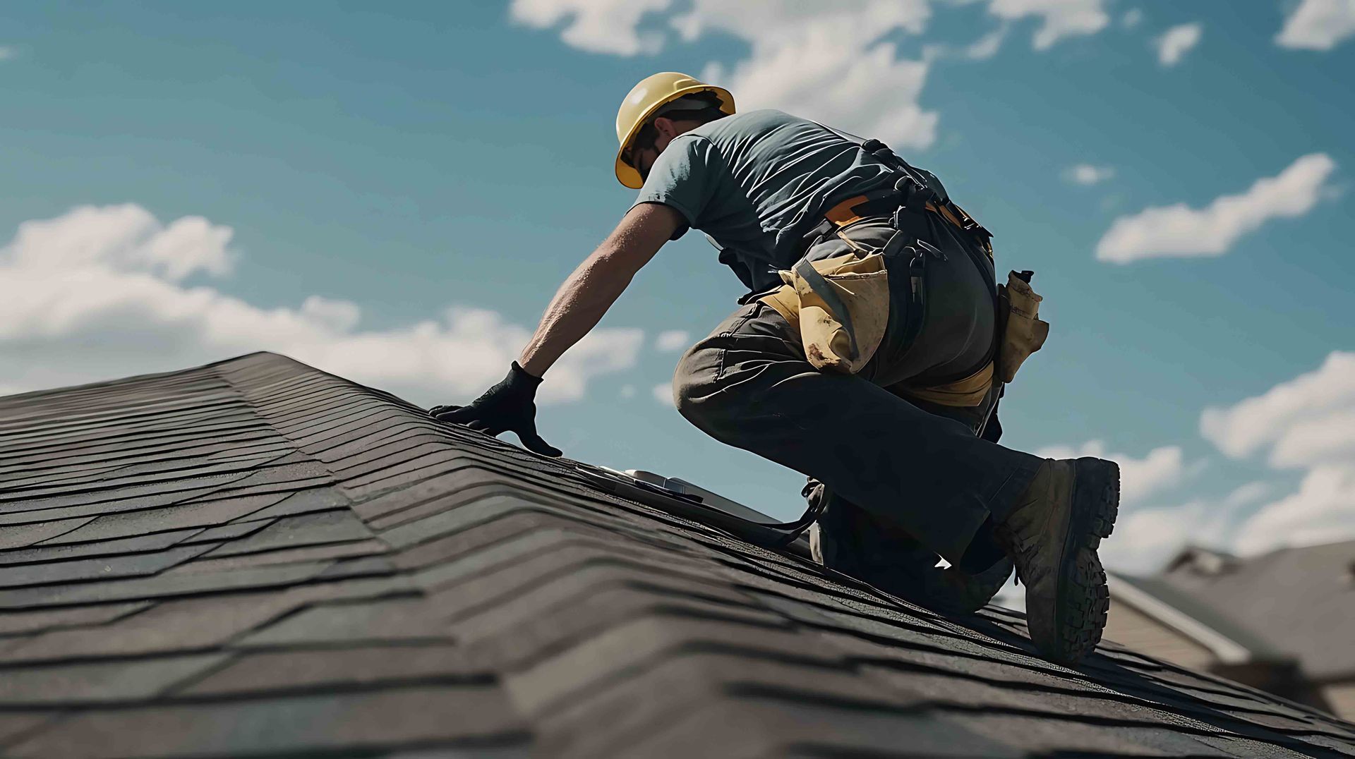 Roofing contractor repairing shingles on a residential home.