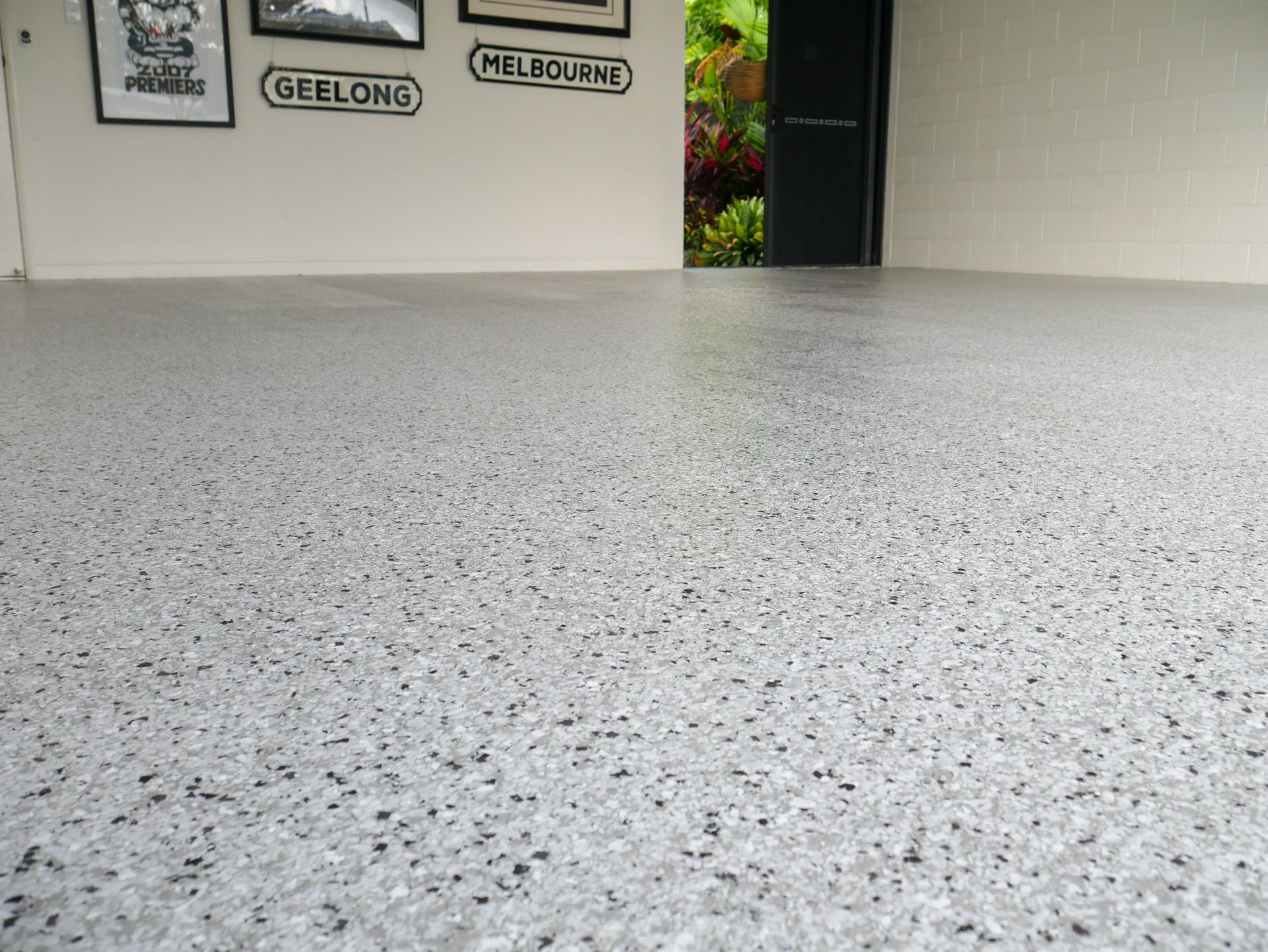 A freshly sealed epoxy floor in a garage in cairns.