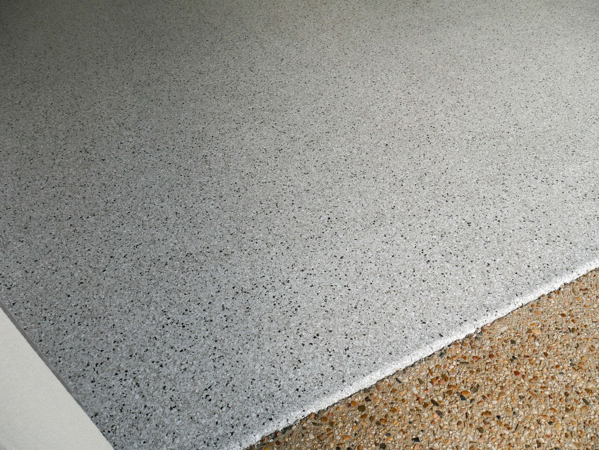 A close up of a white and brown floor with a white border.