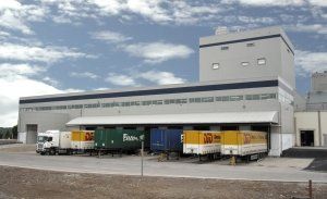 An outside view of the loading bay at Danone factory Ireland with lorry trailers parked under a canopy