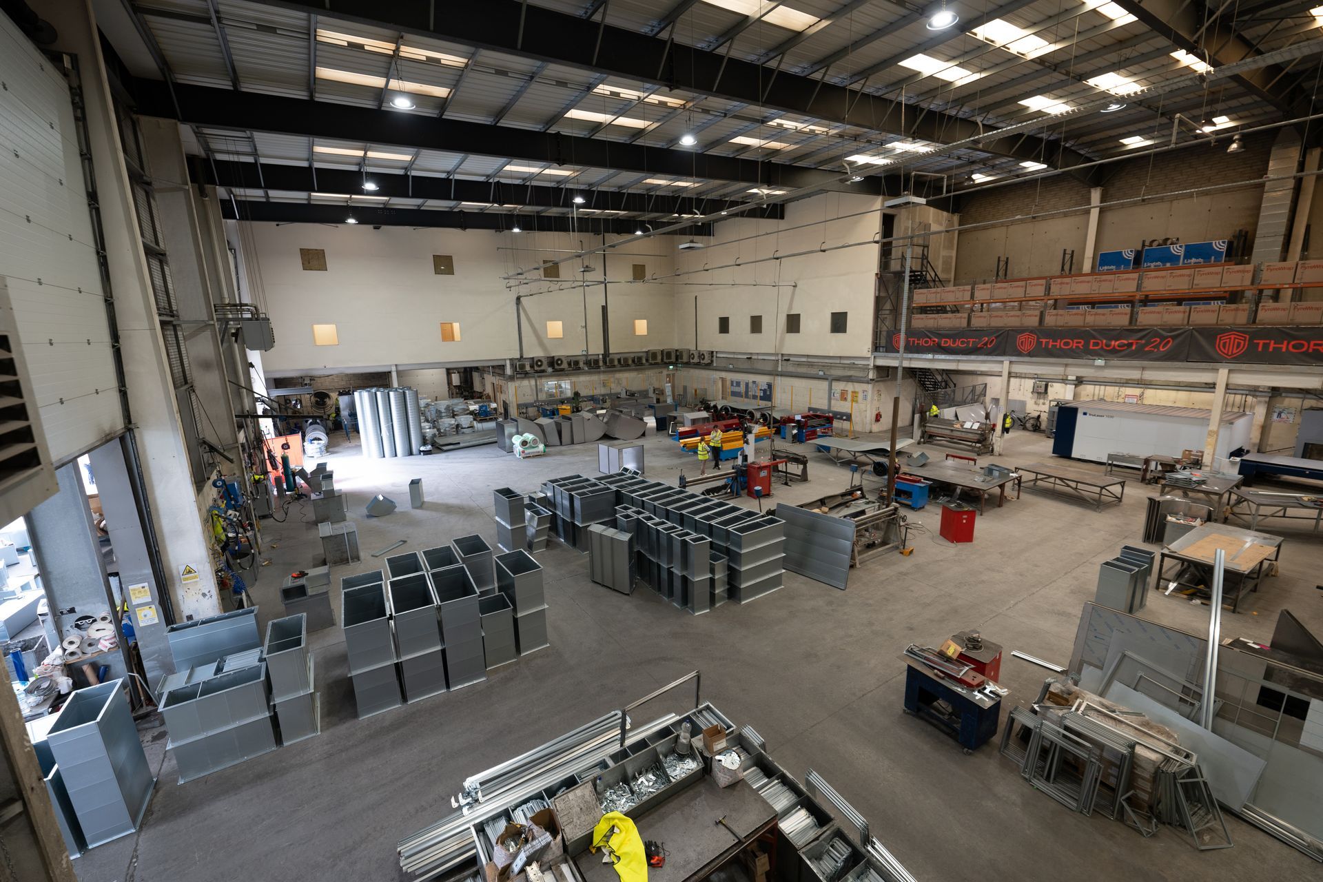  A.C. Manufacturing factory floor from an overhead view with ducting and machines in view 