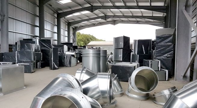 outside view of steel frame of 45,000 sq. ft. expanded manufacturing floor area in 2016 with large metal ducts 