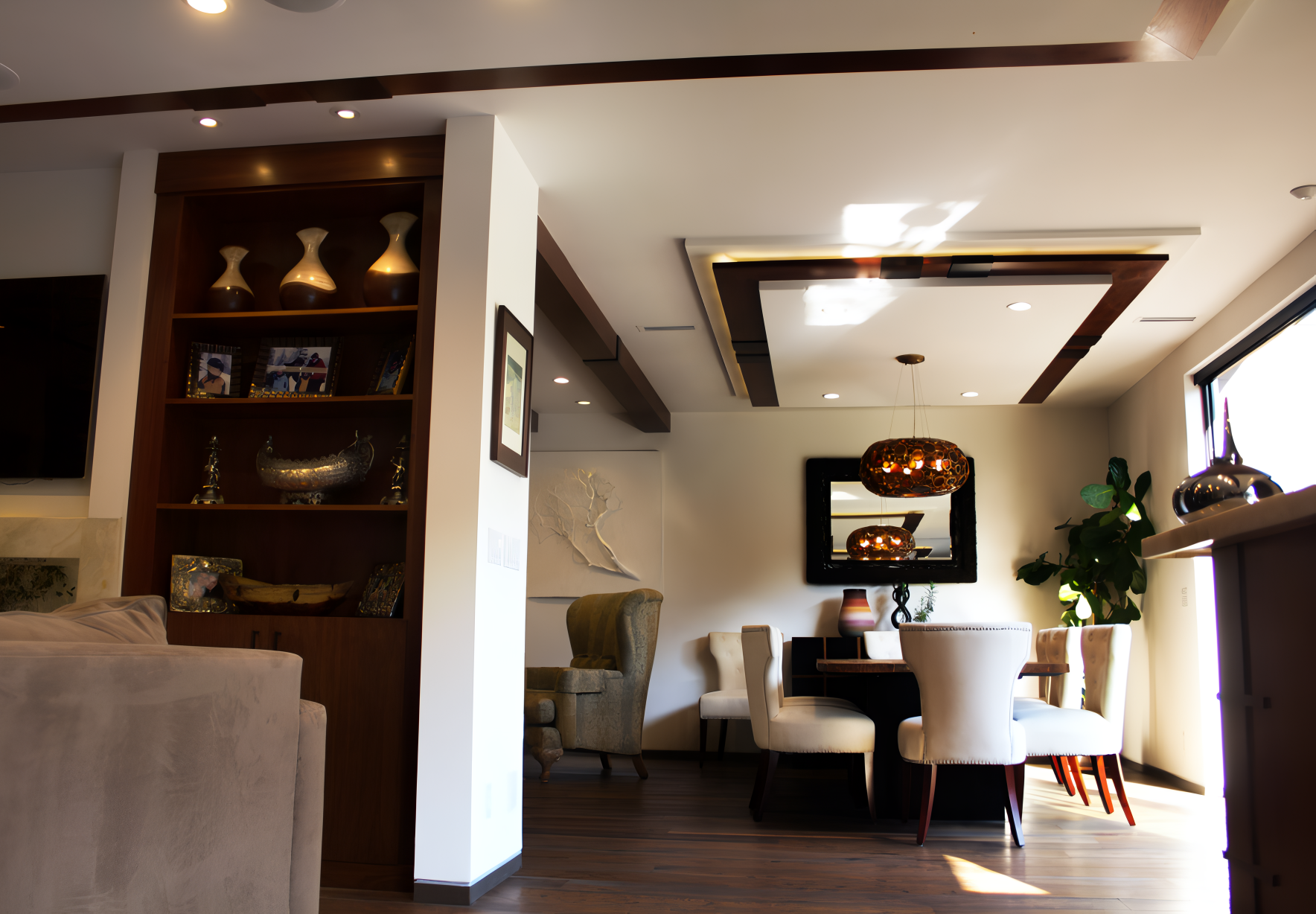Modern dining room with wood accents and a built-in shelving unit.