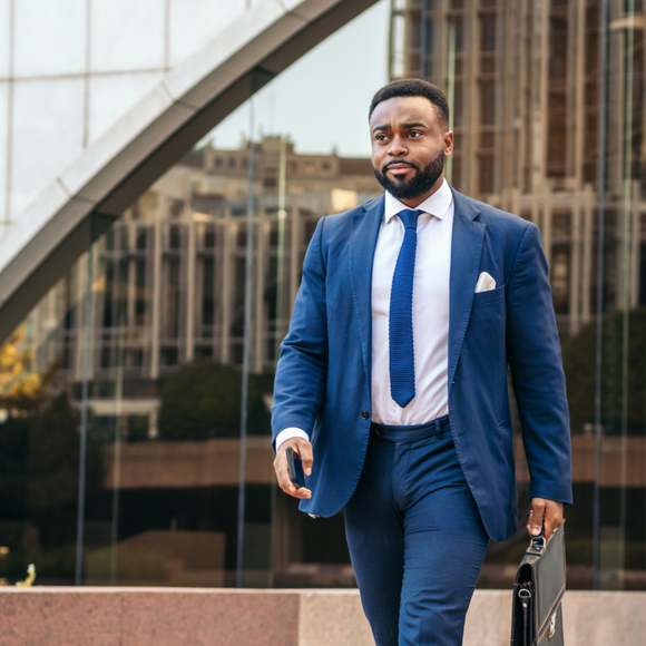 Black businessman walking with a briefcase