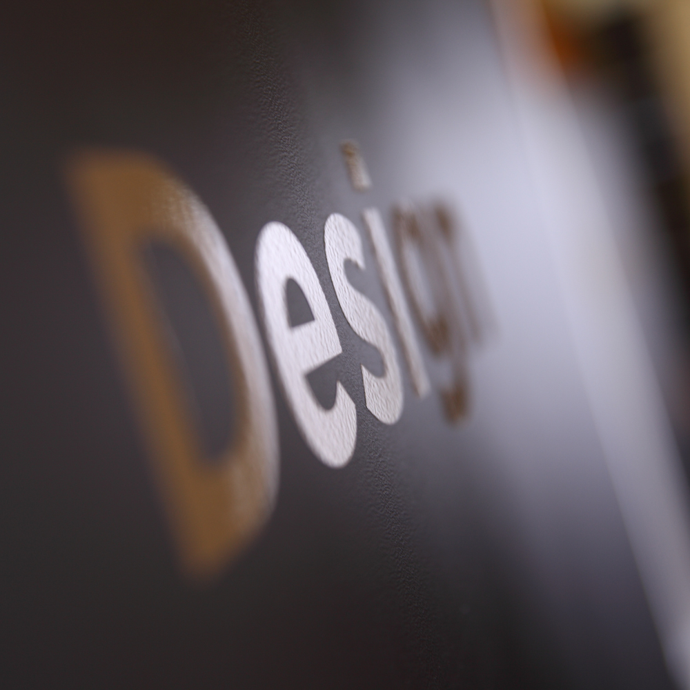 A close up of the word design on a black surface