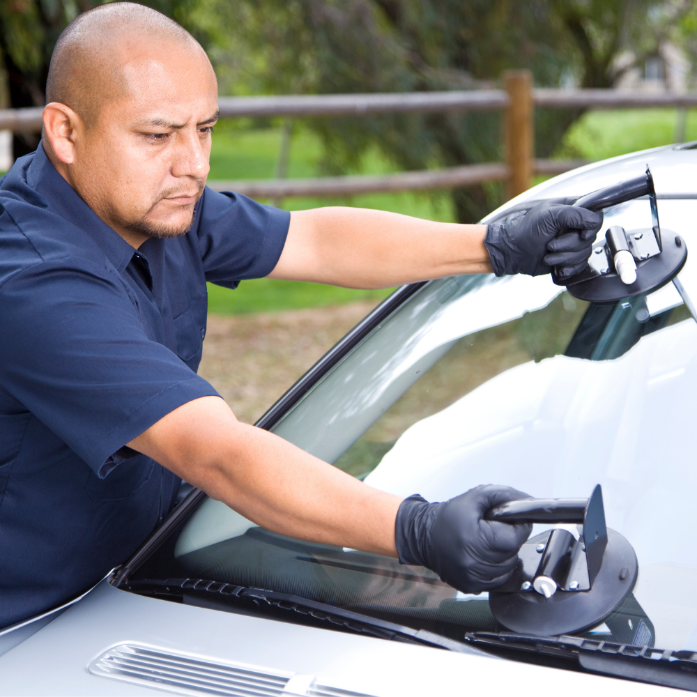 Economy Glass employee fixing windshield 