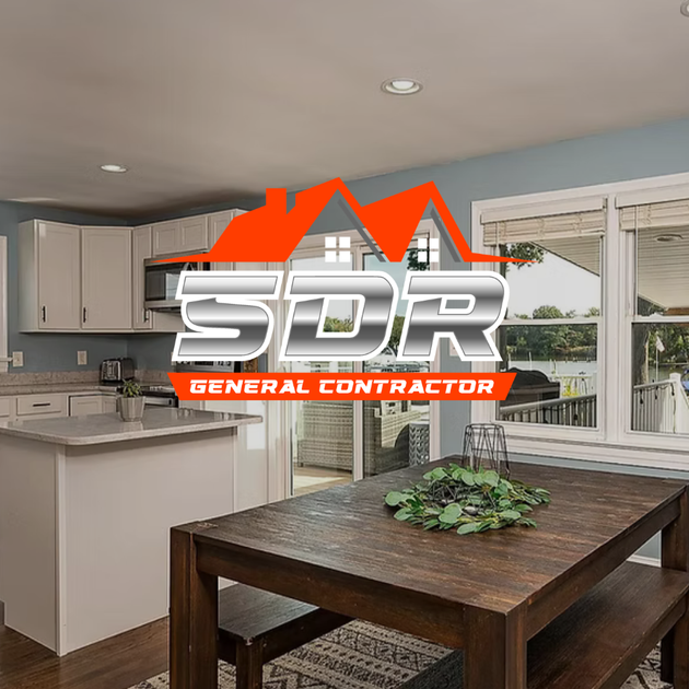 Modern kitchen and dining area with dark wood table, light cabinets, and large windows, overlaid with SDR General Contractor logo