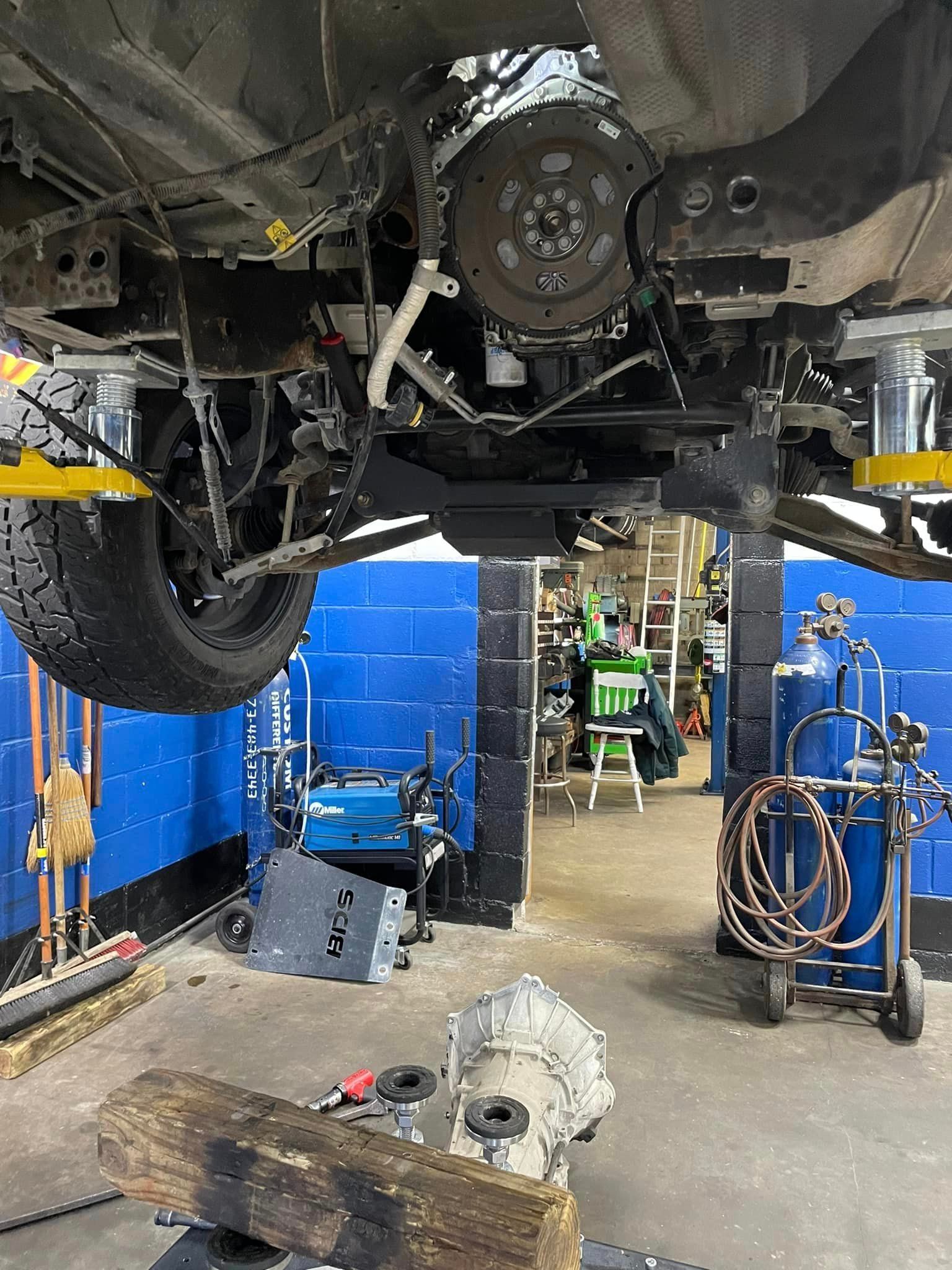 A car is being worked on in a garage.