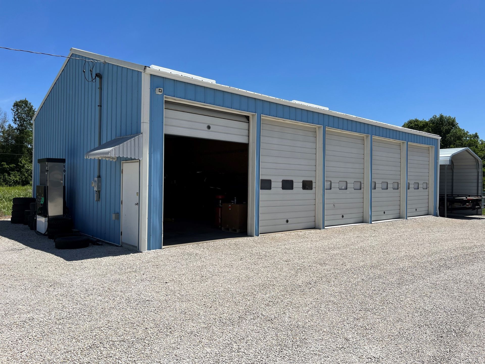 A blue building with white doors and a blue sky in the background