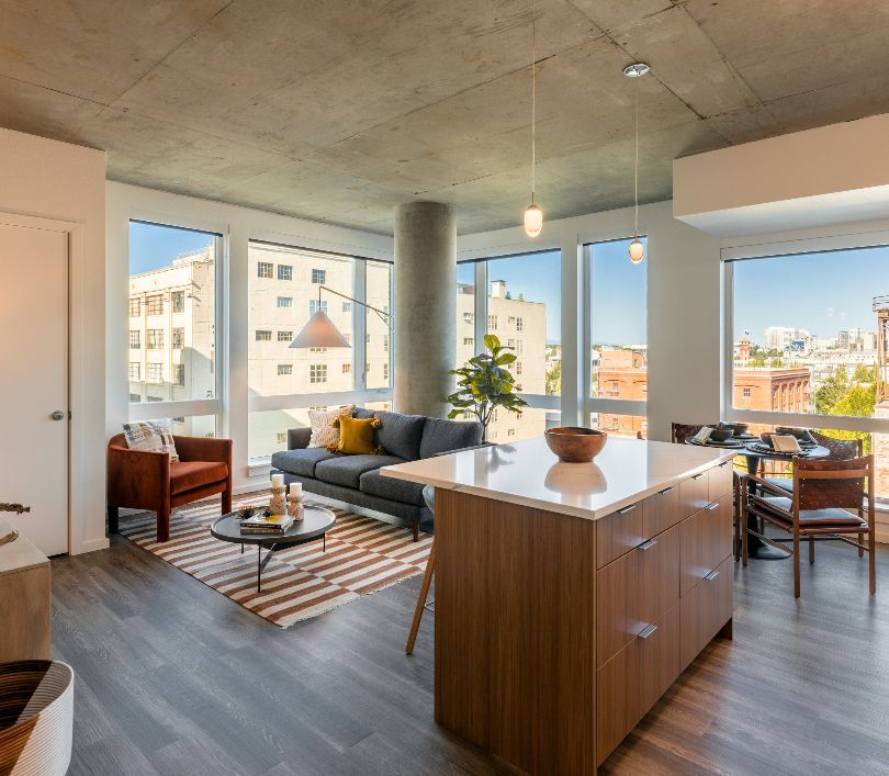 A large kitchen with stainless steel appliances , granite counter tops , and wooden floors.