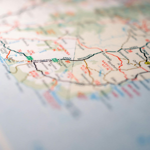 Close-up of a folded road map with a black route line and colorful place names