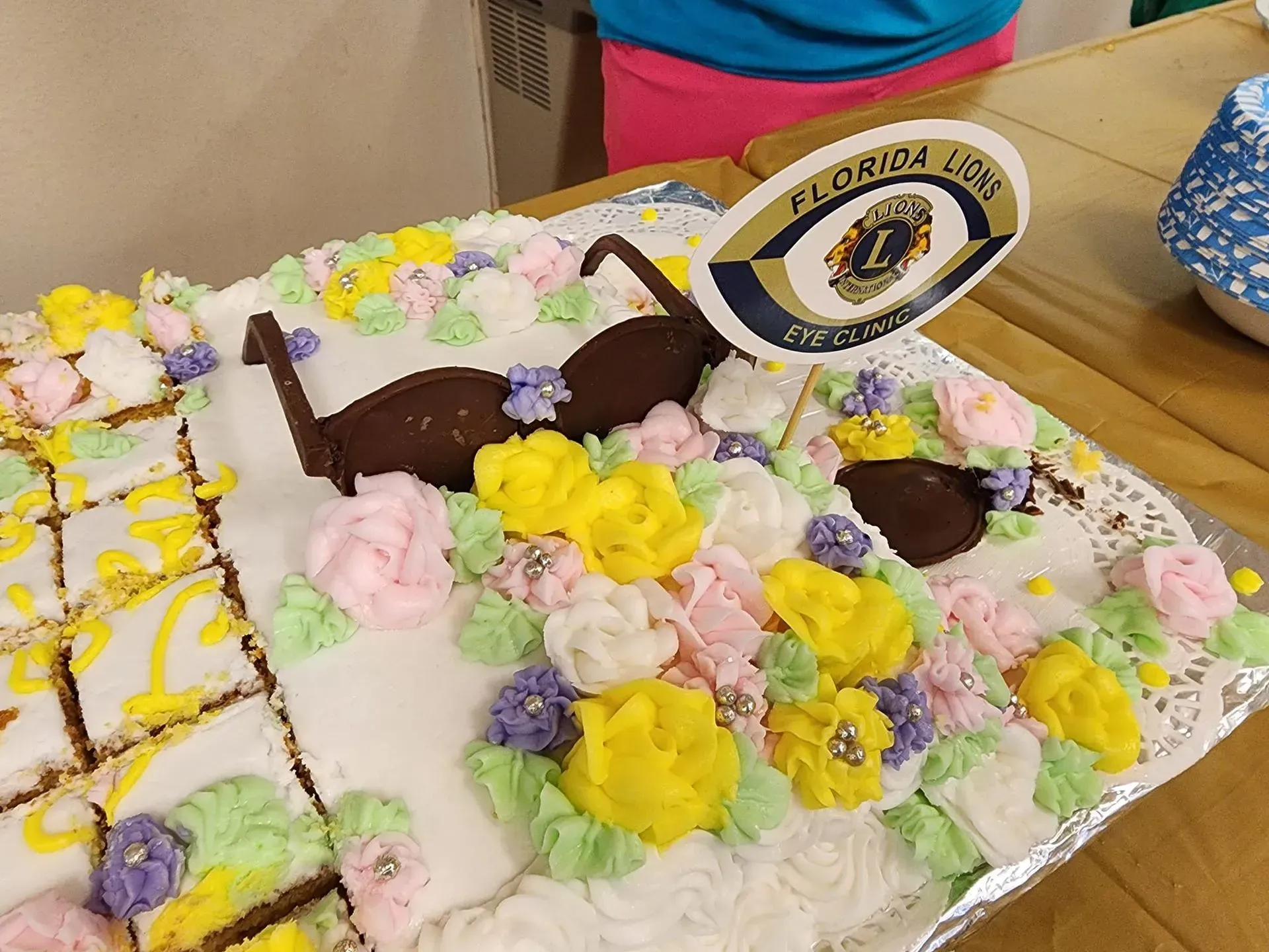 Cake decorated with frosting flowers, sunglasses, and a "Florida Lions" logo.