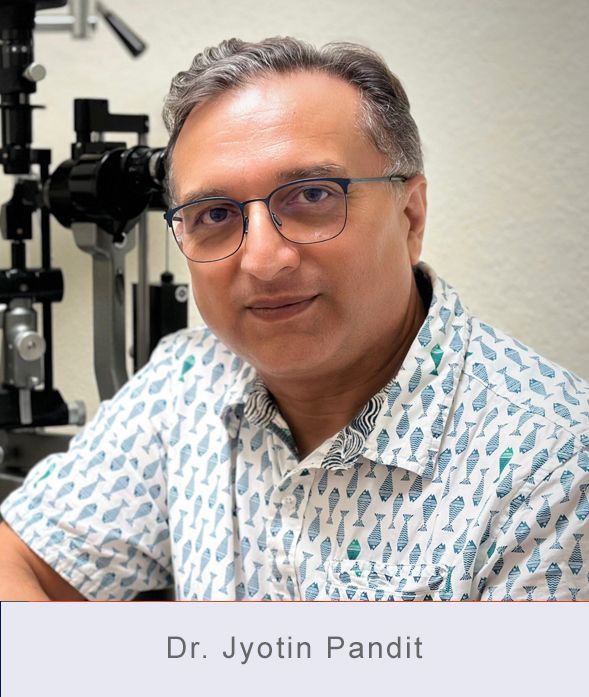 Dr. Jyotin Pandit wearing glasses, smiling, in front of an eye exam machine.