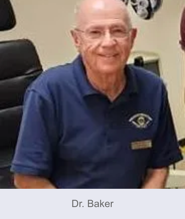 Dr. Baker wearing glasses and a blue polo shirt, smiling in an office setting.