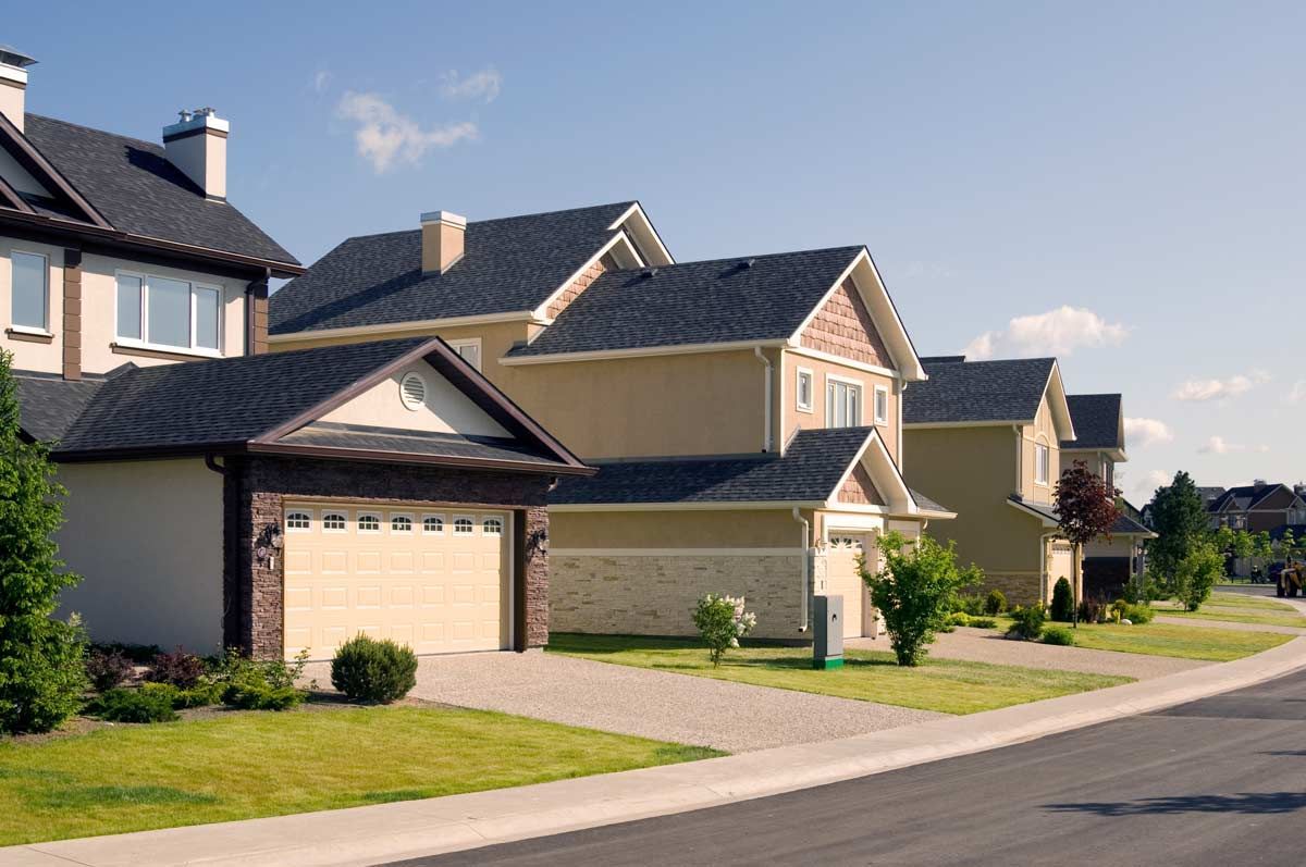 A row of houses on a sunny day in a residential neighborhood