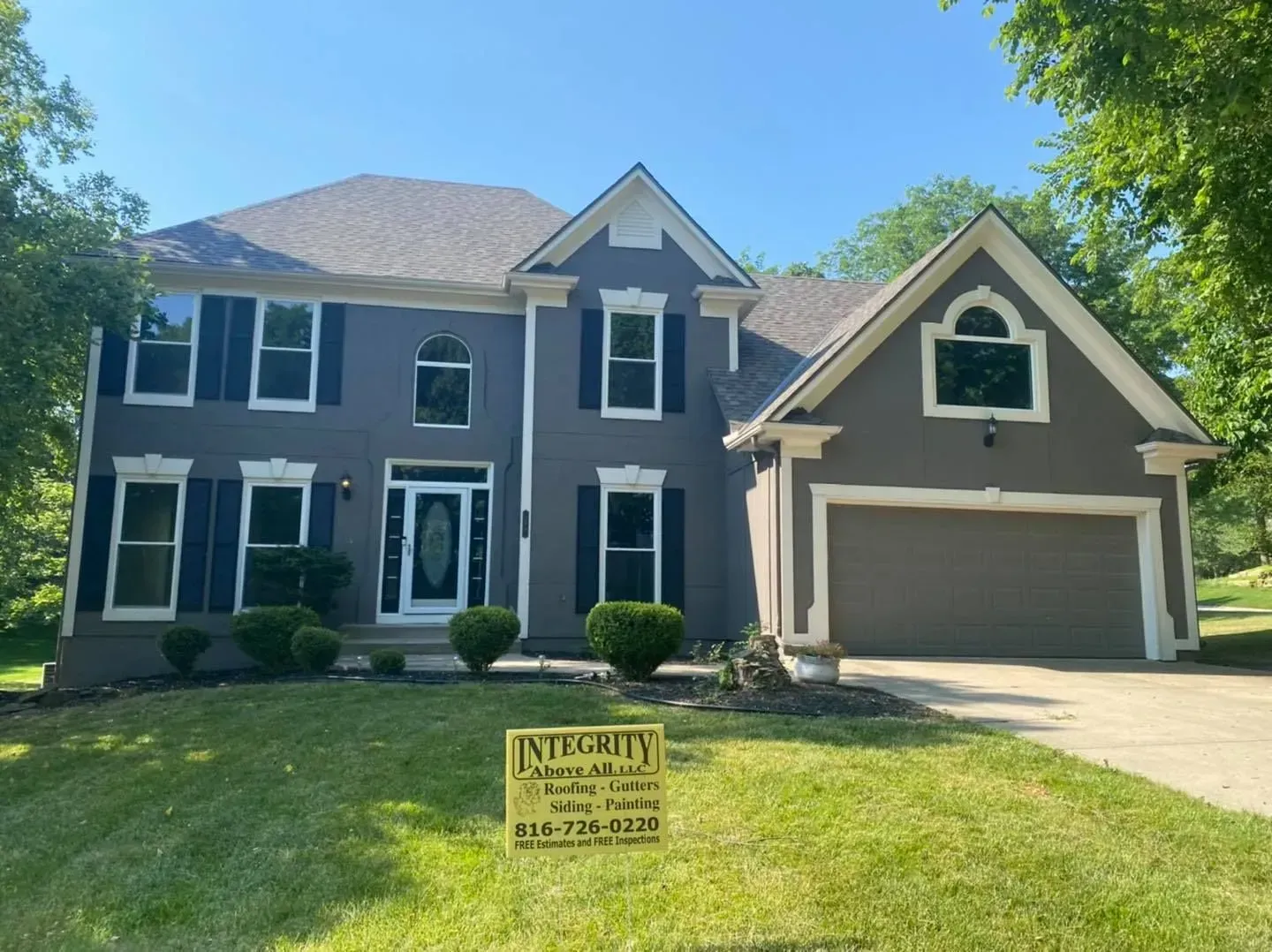 A large house with a yellow sign in front of it