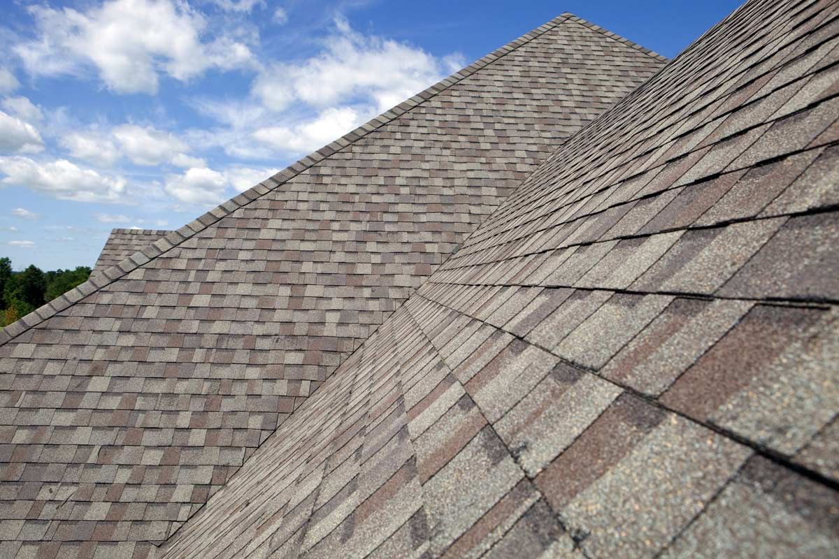 A close up of a roof with a blue sky in the background