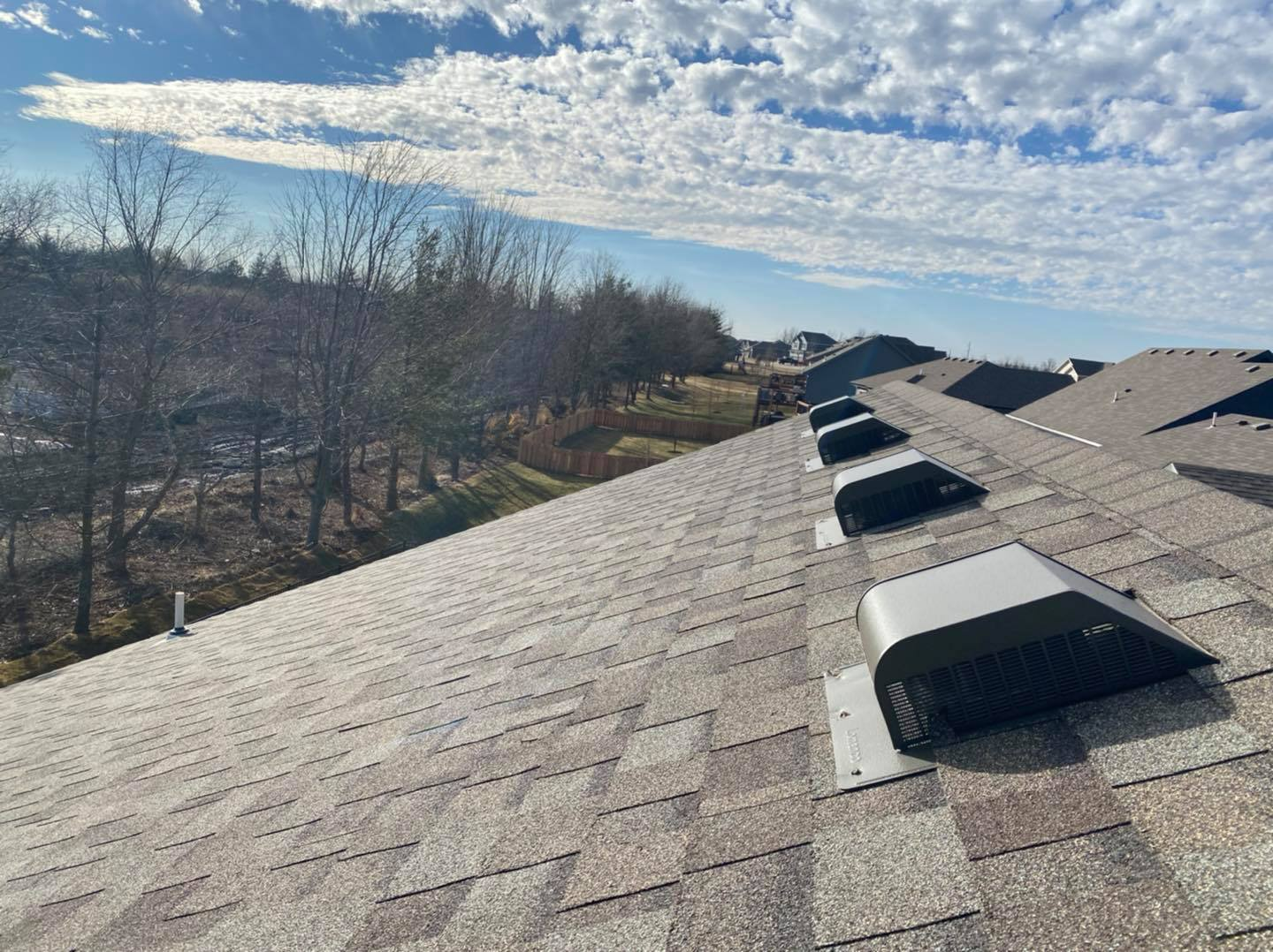 A couple of men are working on a roof