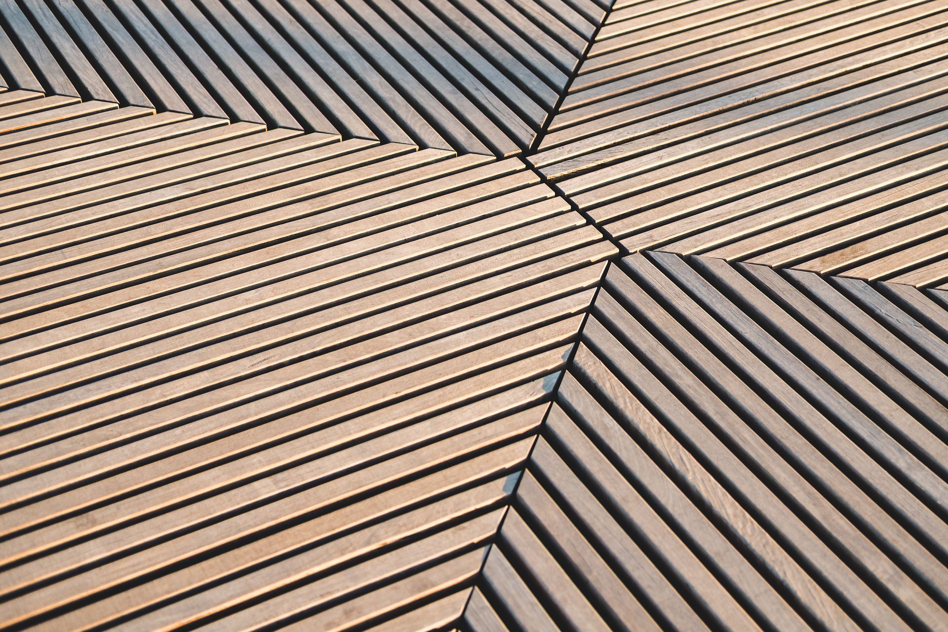 Wooden deck with geometric, angled plank design.