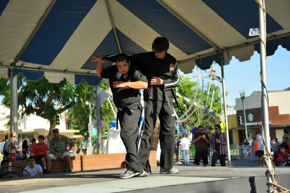 A man is carrying another man on his back under a tent