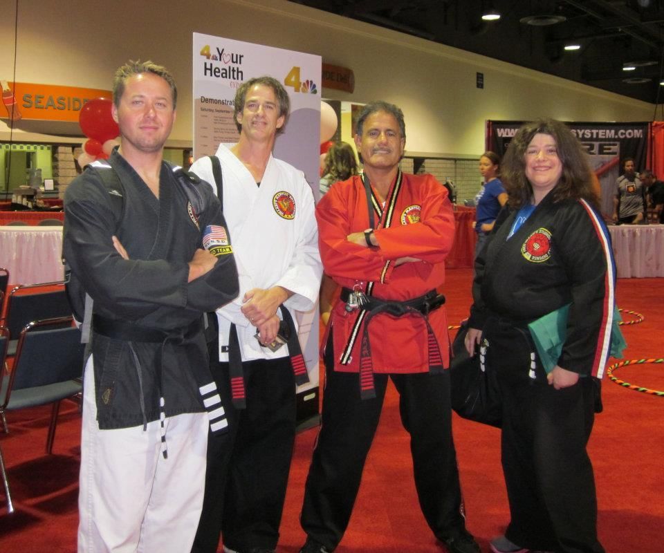 A group of people standing in front of a sign that says your health