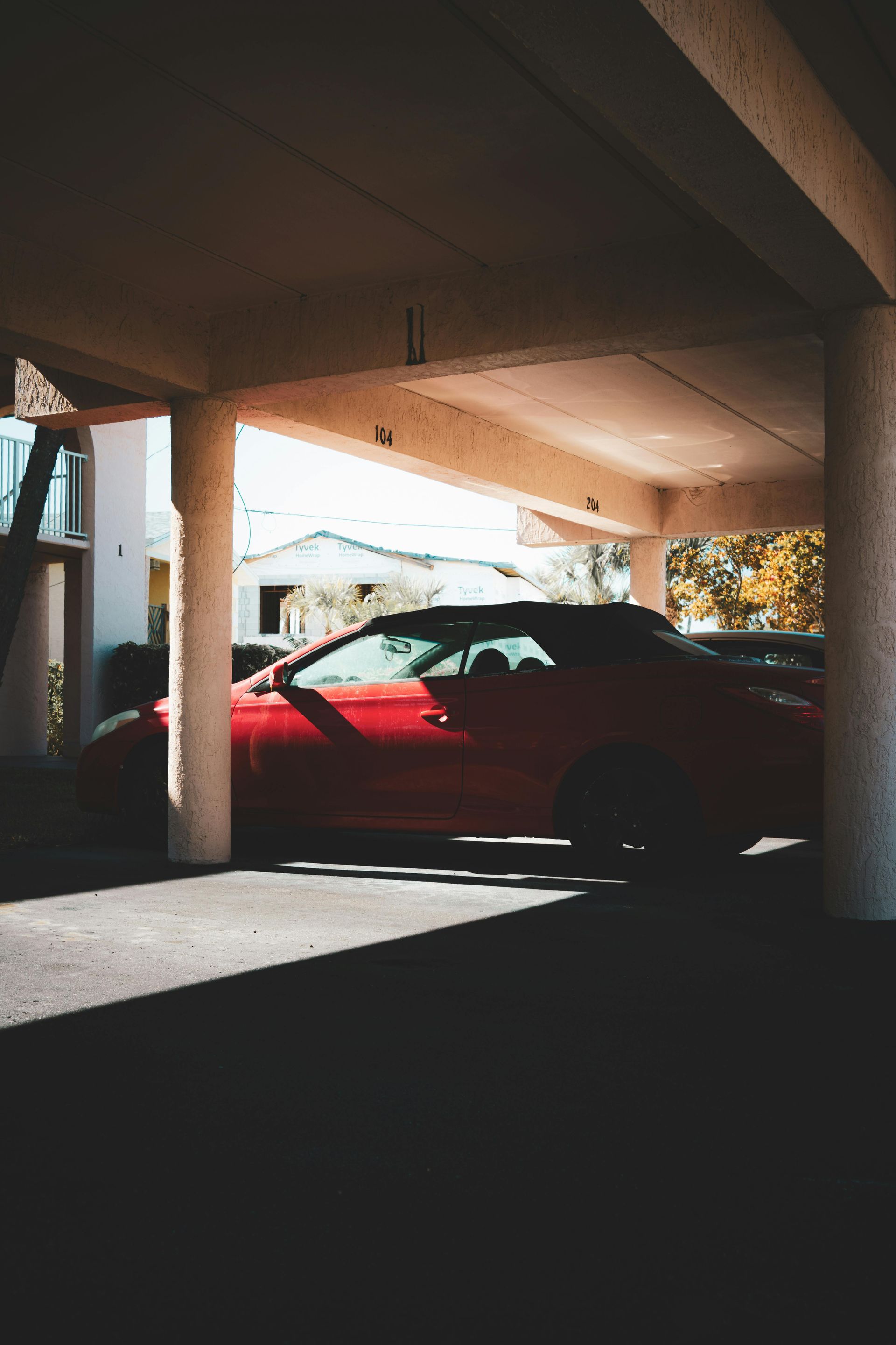 RED VINTAGE SEDAN OARKED UNDERGROUND