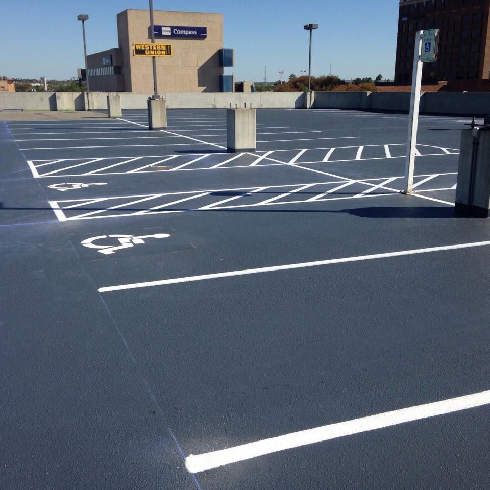 A parking lot with a handicap sign on it