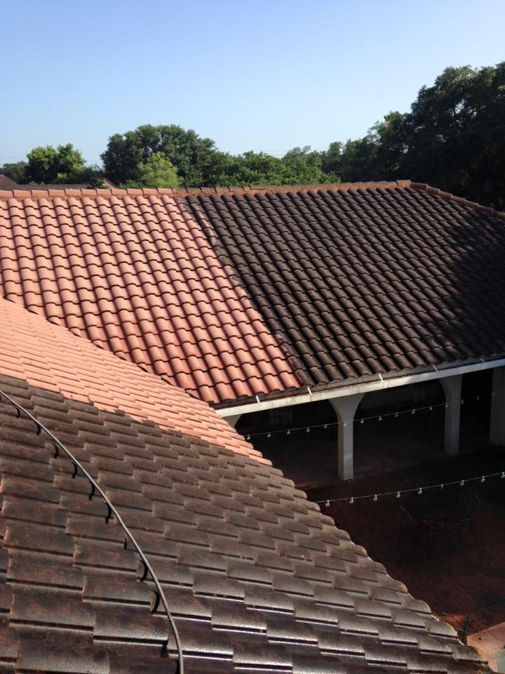 A roof with red tiles and a black tile roof