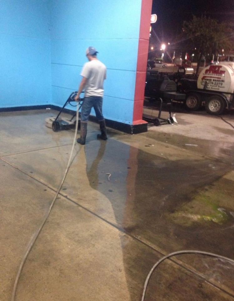 A sidewalk with cars parked on the side of it.