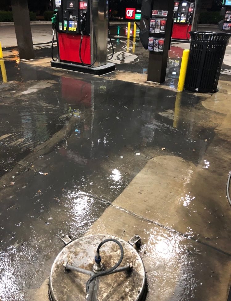 A sidewalk with cars parked on the side of it.