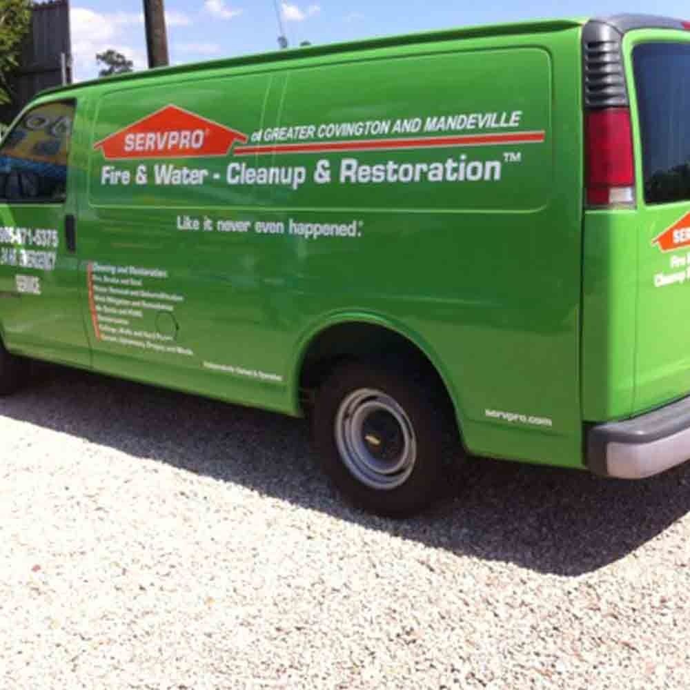Green SERVPRO van for fire and water cleanup and restoration in Covington and Mandeville.