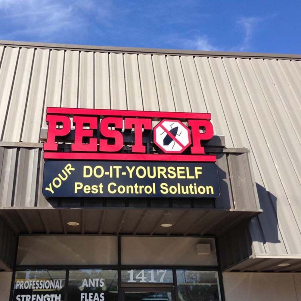 Sign for PESTOP, a DIY pest control store, with red letters and a cockroach symbol. Address: 1417.