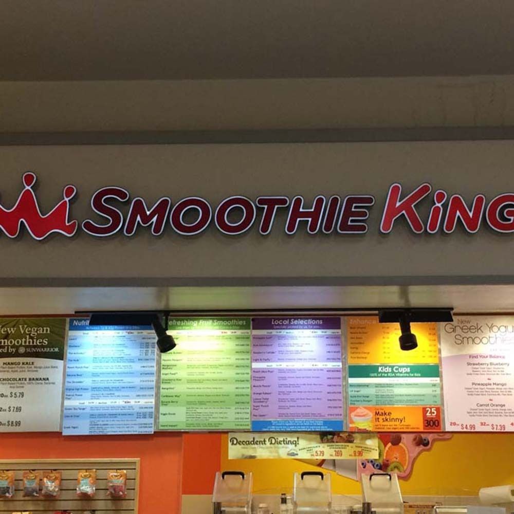 Smoothie King sign above colorful menu boards.