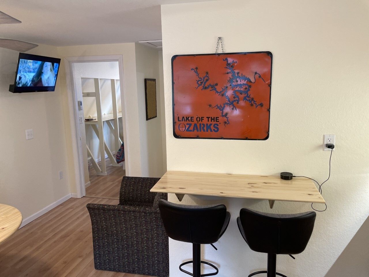 A living room with a sign on the wall that says lake of the hazards
