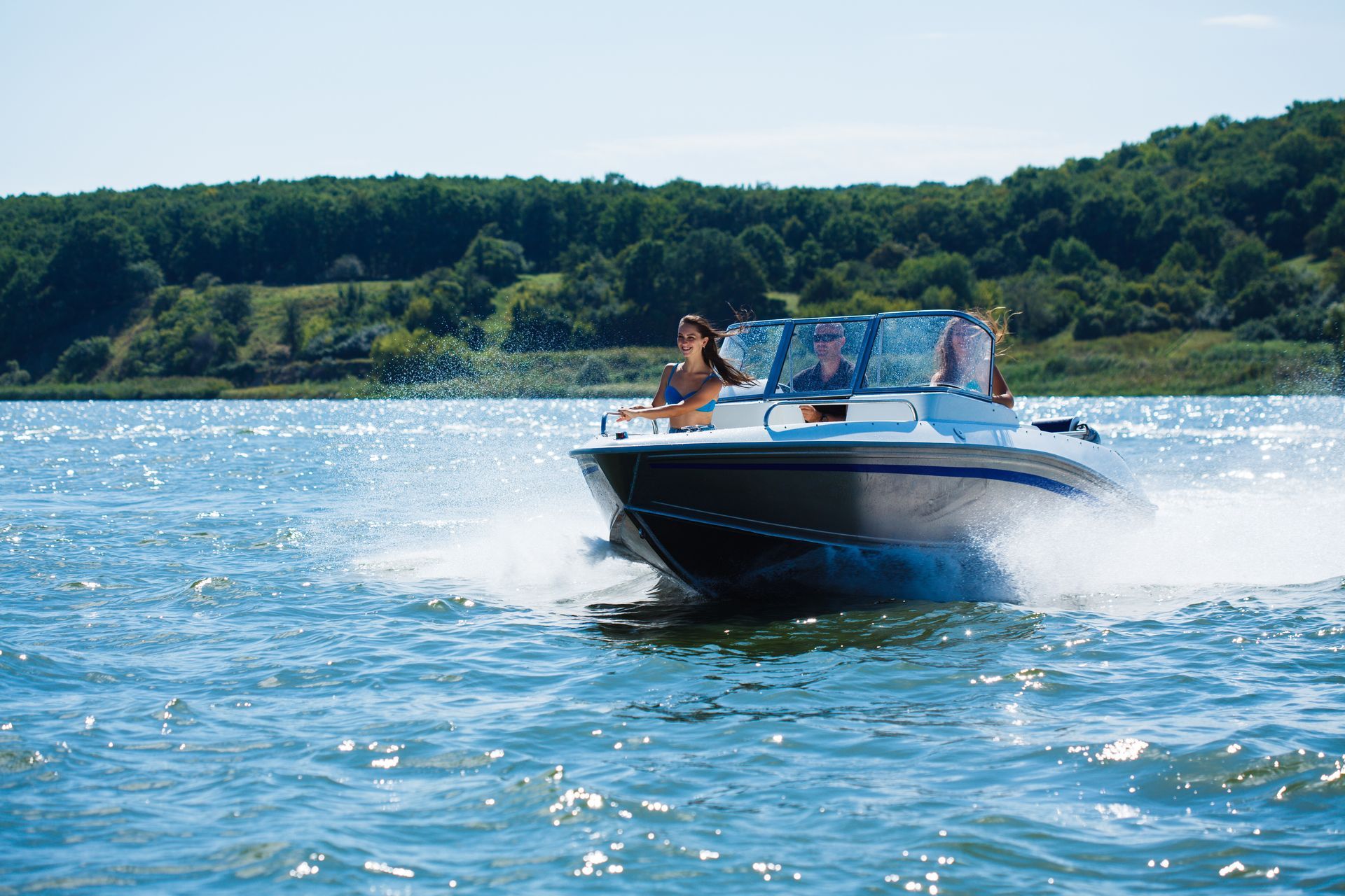 A group of people are riding a boat on a lake.