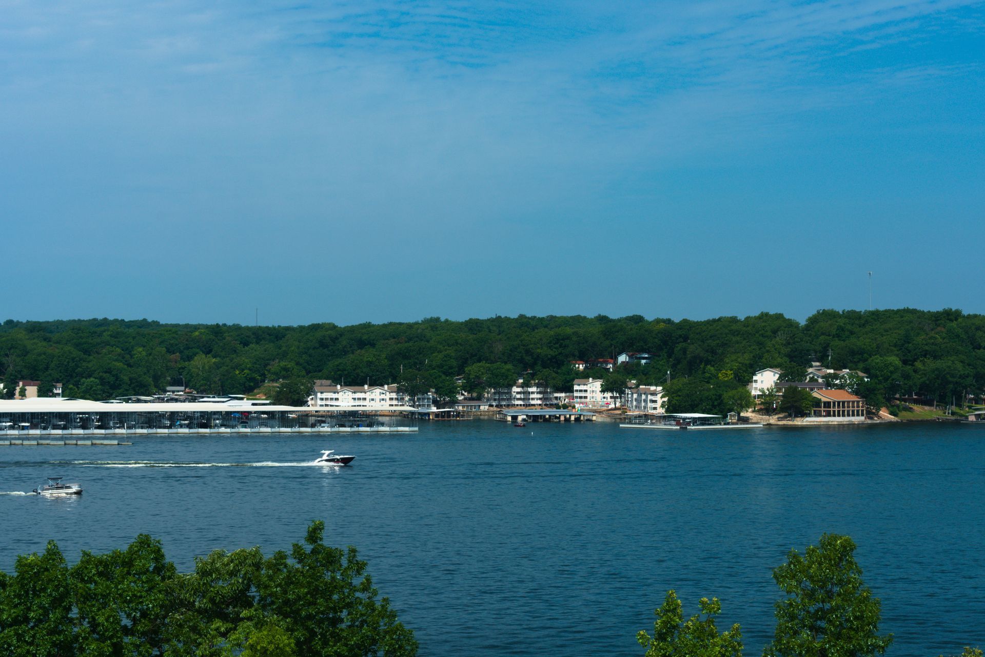 A boat is floating on top of a large body of water.