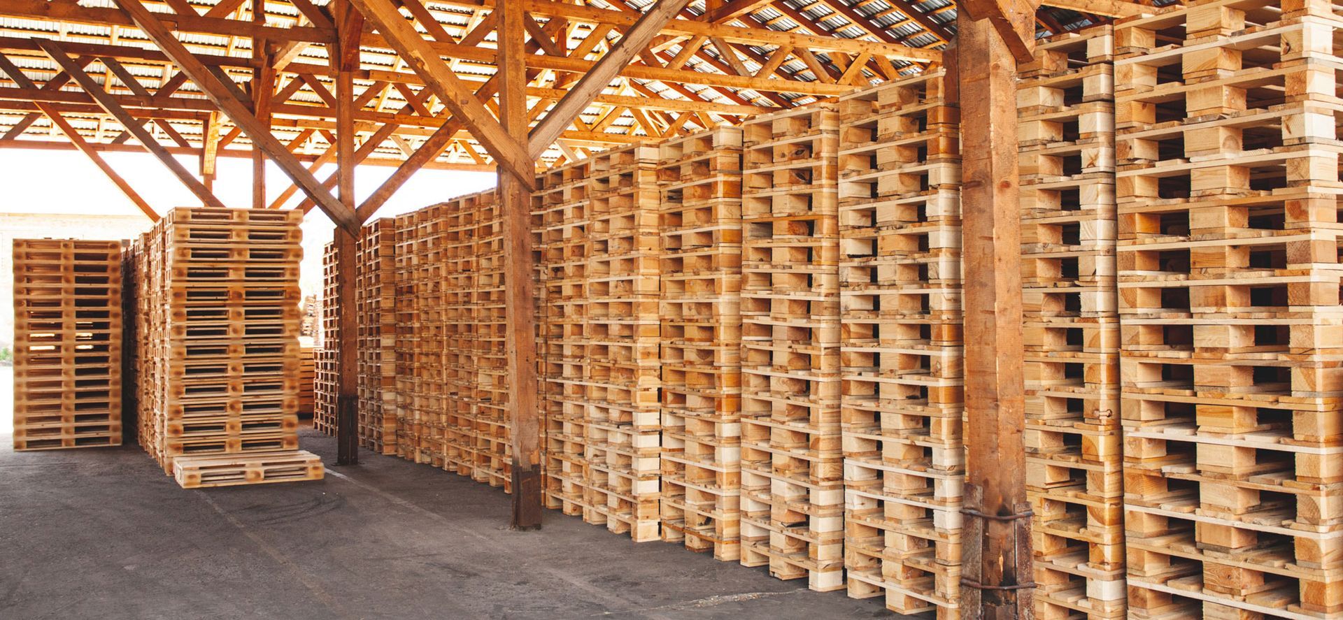 wooden pallets stacked on top of each other in an open facility