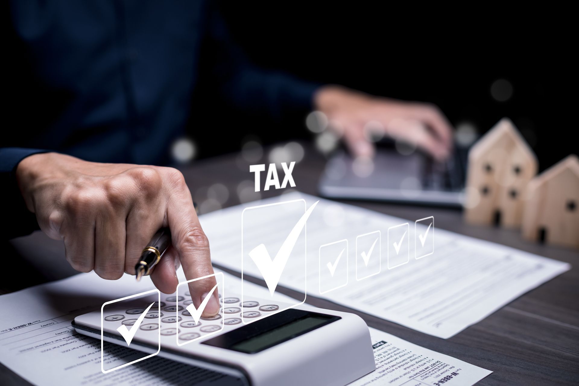 A person is using a calculator to calculate taxes