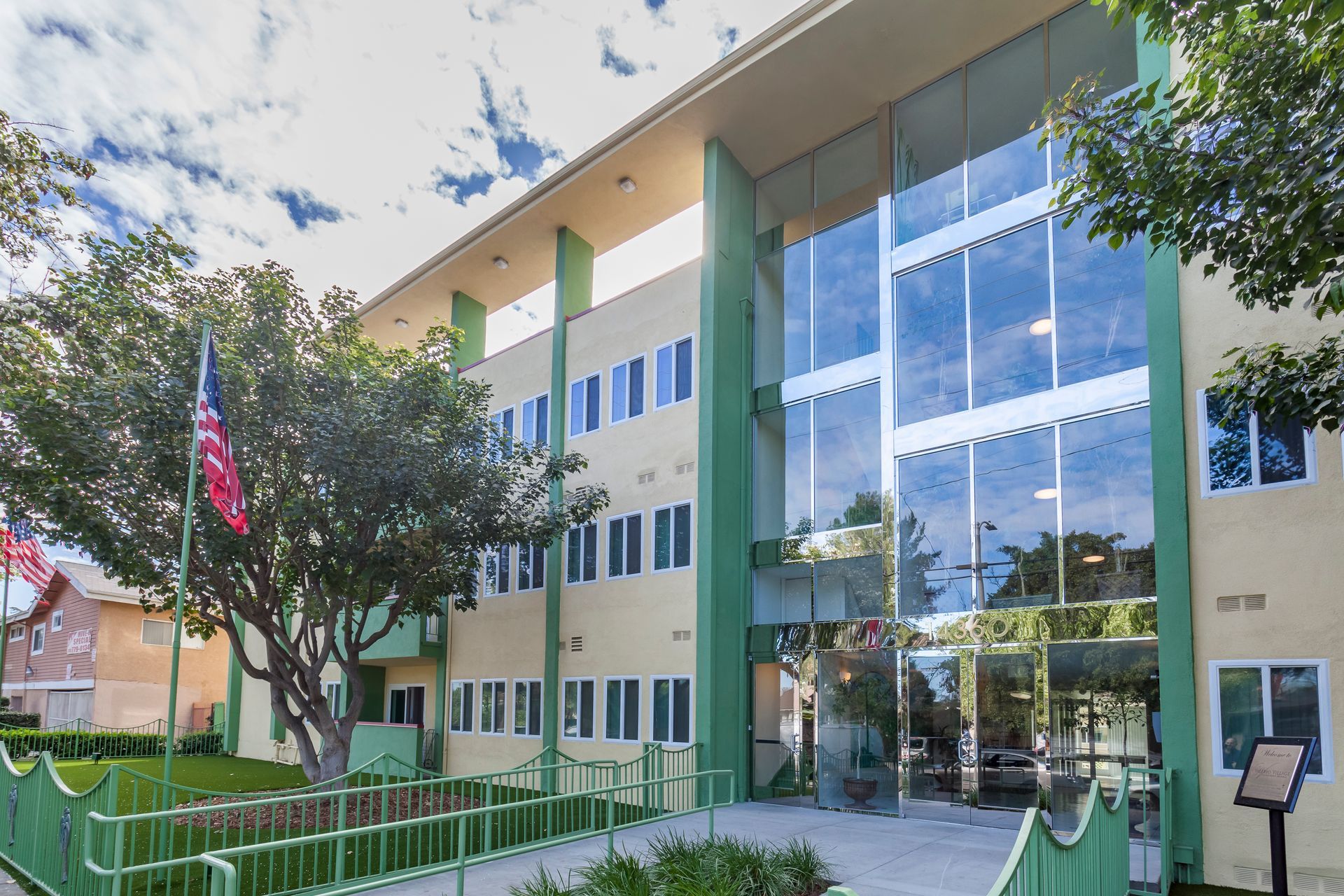 A large building with a lot of windows and a tree in front of it