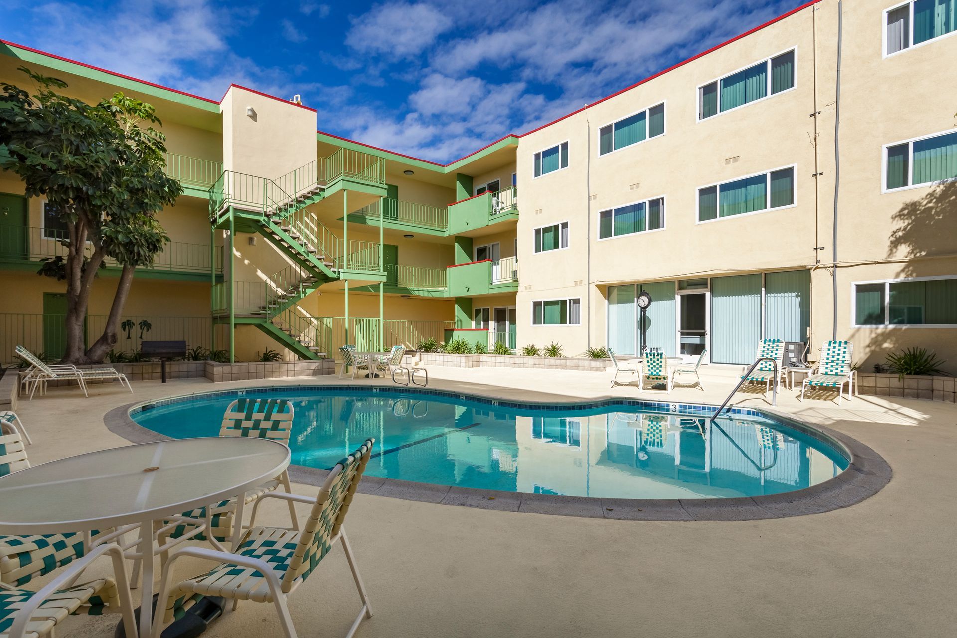 A large building with a swimming pool in front of it