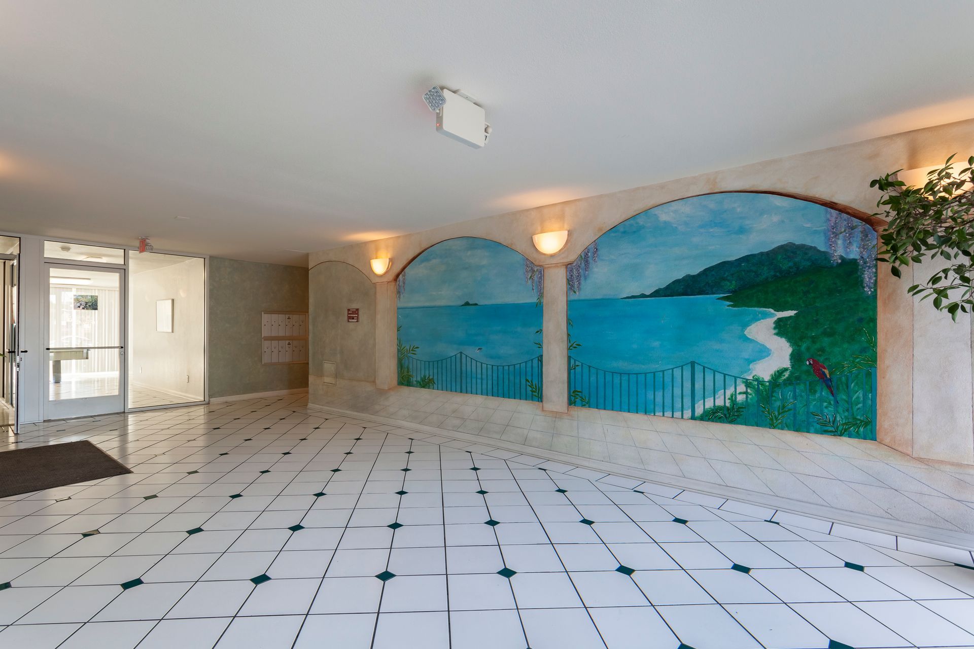 A hallway with a painting of the ocean on the wall
