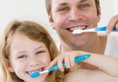 Father and daughter toothbrushing - Dental Implants in in Newport News, VA