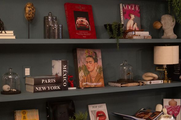 A shelf with a painting of frida kahlo on it