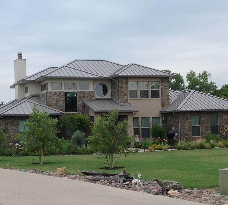 A large brick house with a metal roof