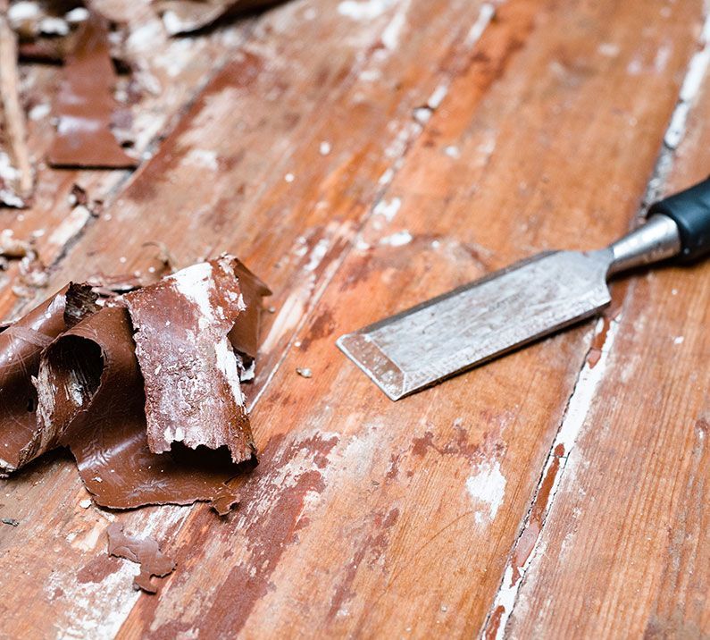 A chisel is sitting on top of a wooden table.