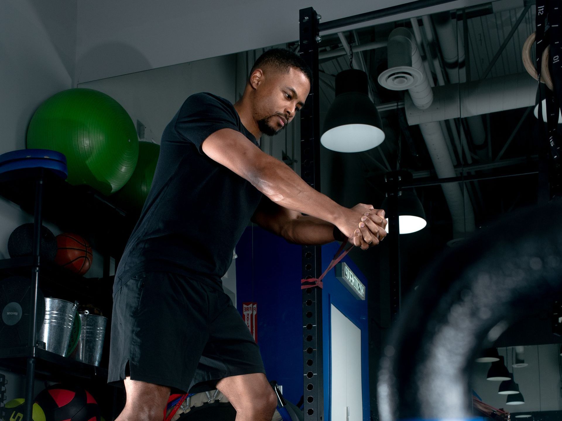 a man is using a resistance band in a gym